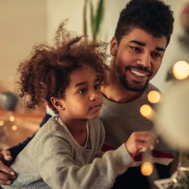 Child with Autism Spectrum Disorder playing with father