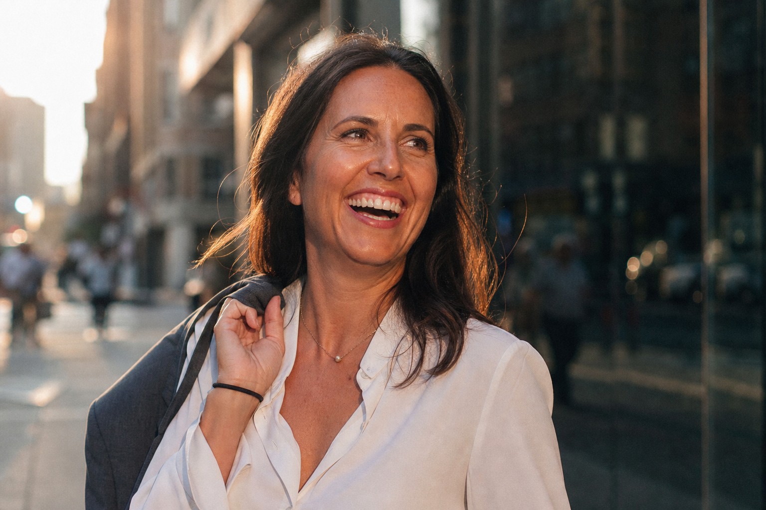 A smiling woman outdoors in warm afternoon light, the positive after of starting depression therapy.