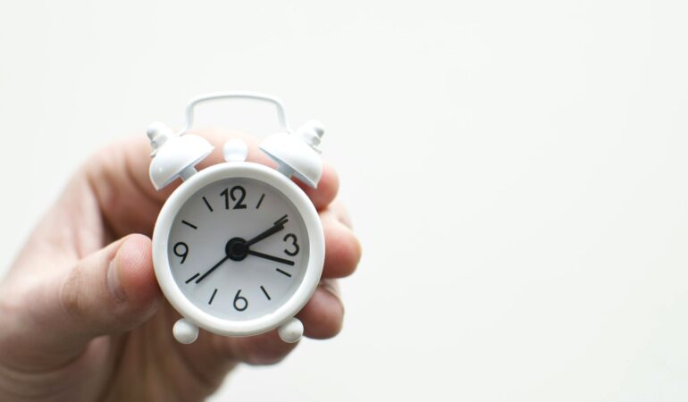 Analog clock on a table marking the short window of a panic attack peak.